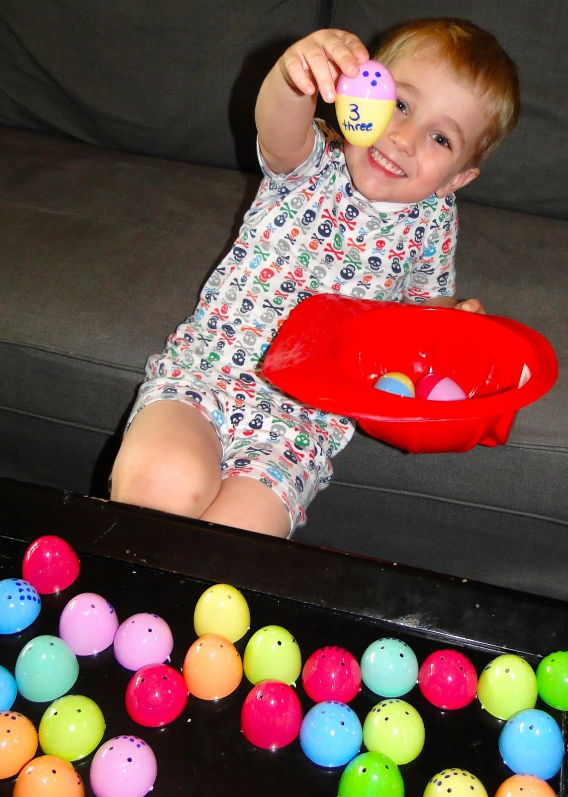 Child playing with toy eggs