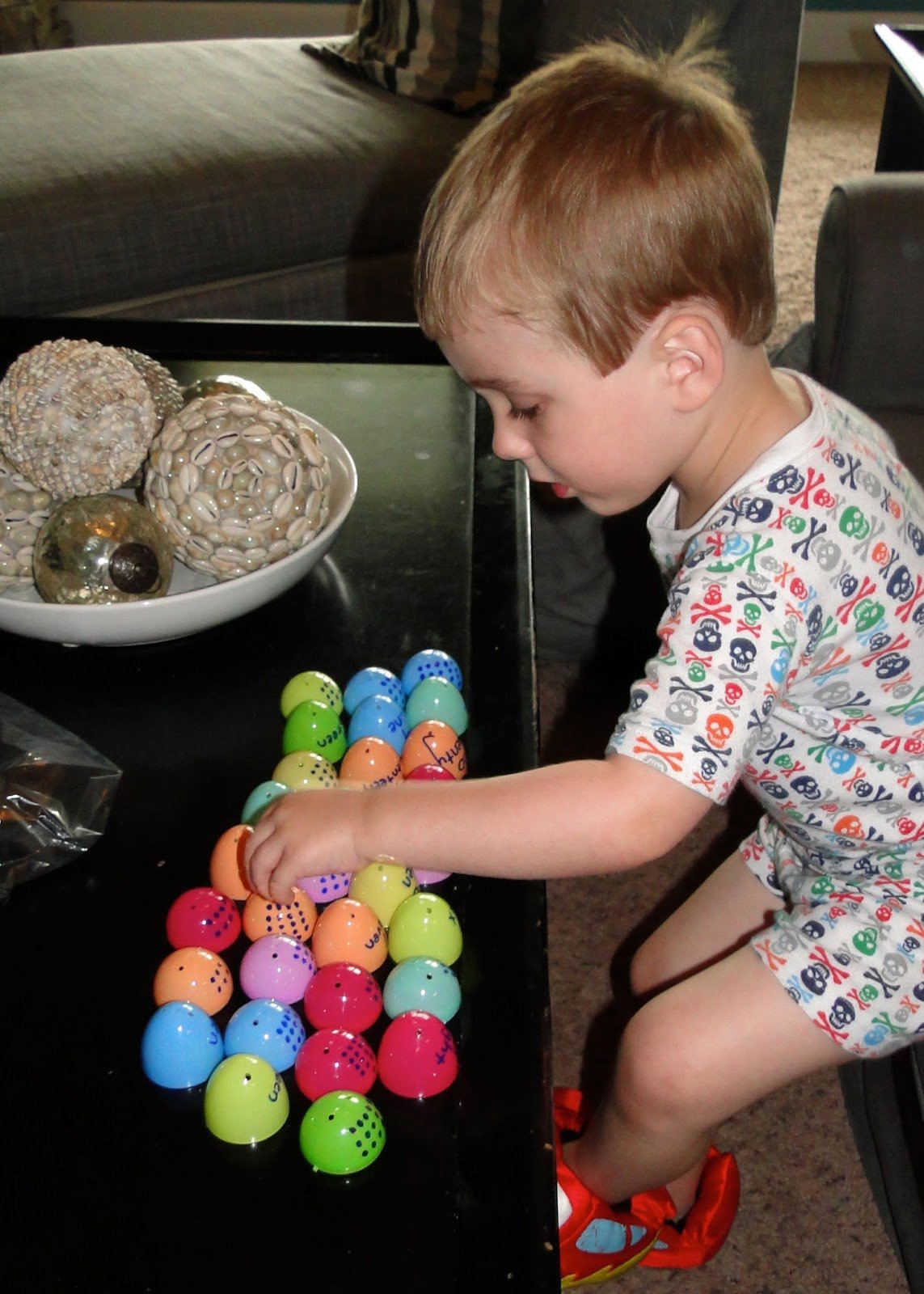 Child playing with toy eggs