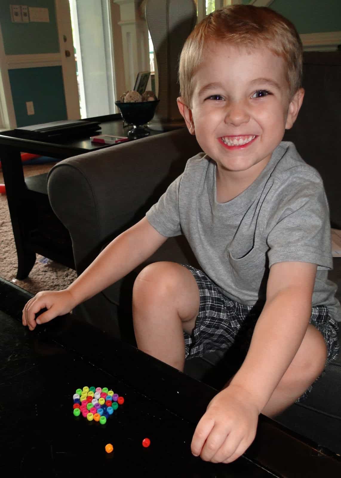 boy playing with beads