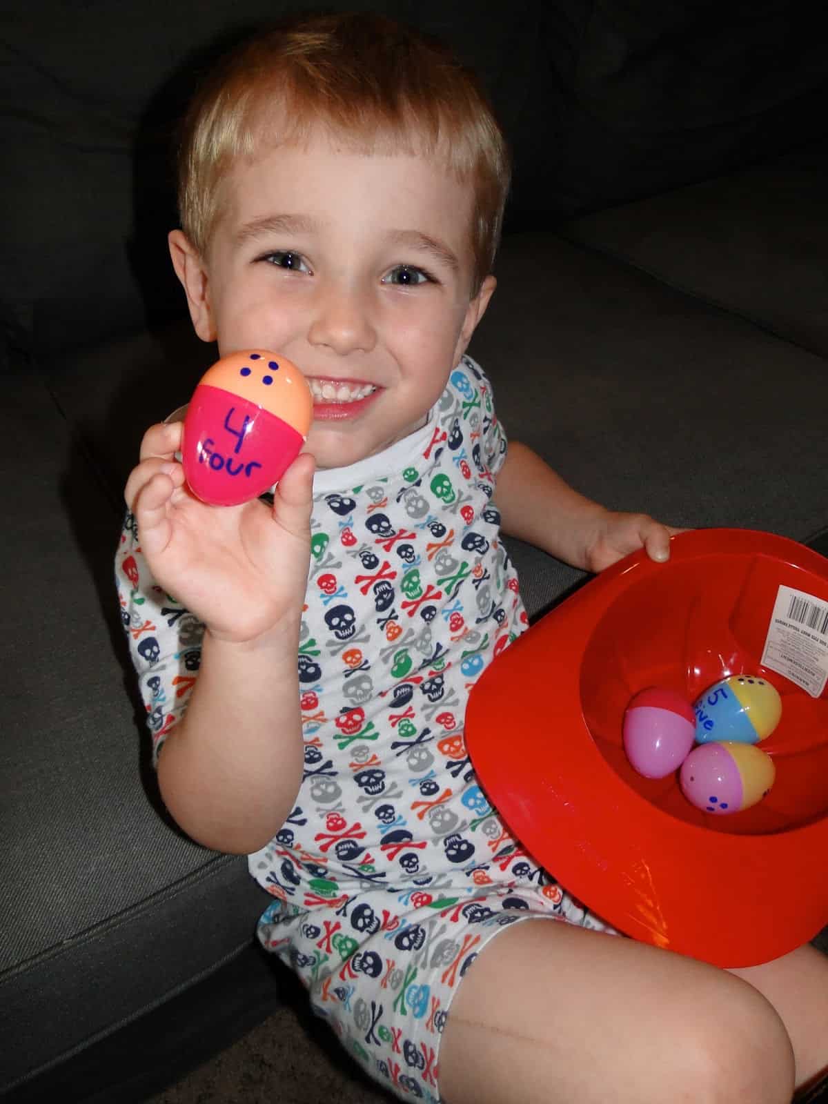 Child playing with toy eggs