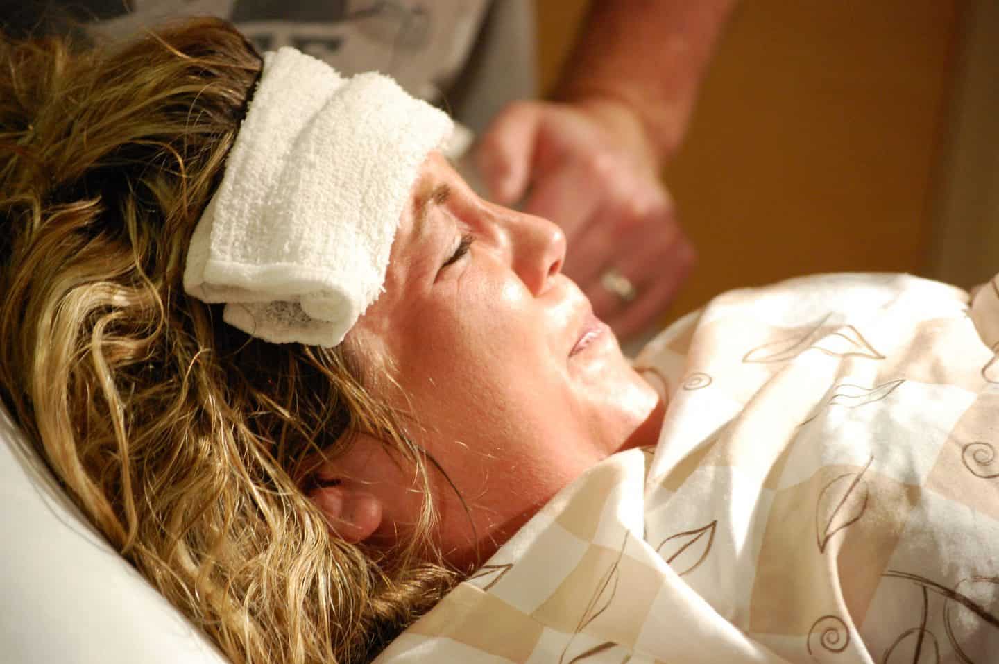 woman experiencing natural childbirth pushing