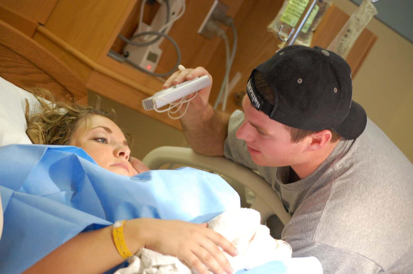 husband fanning wife during childbirth