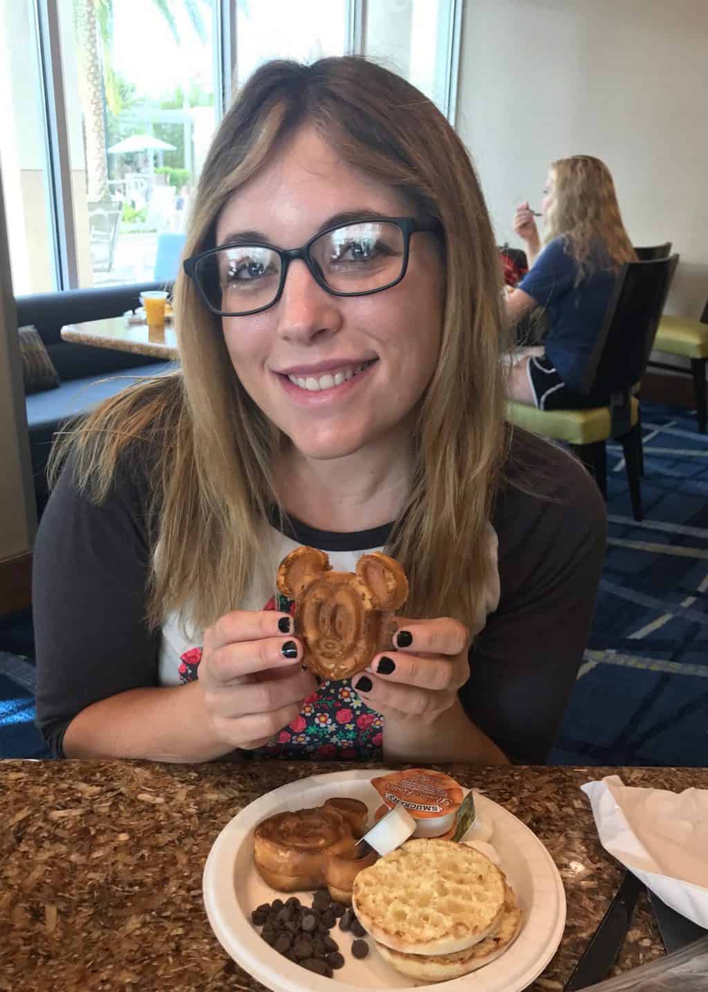 woman with mickey waffle is it worth staying at a disney resort