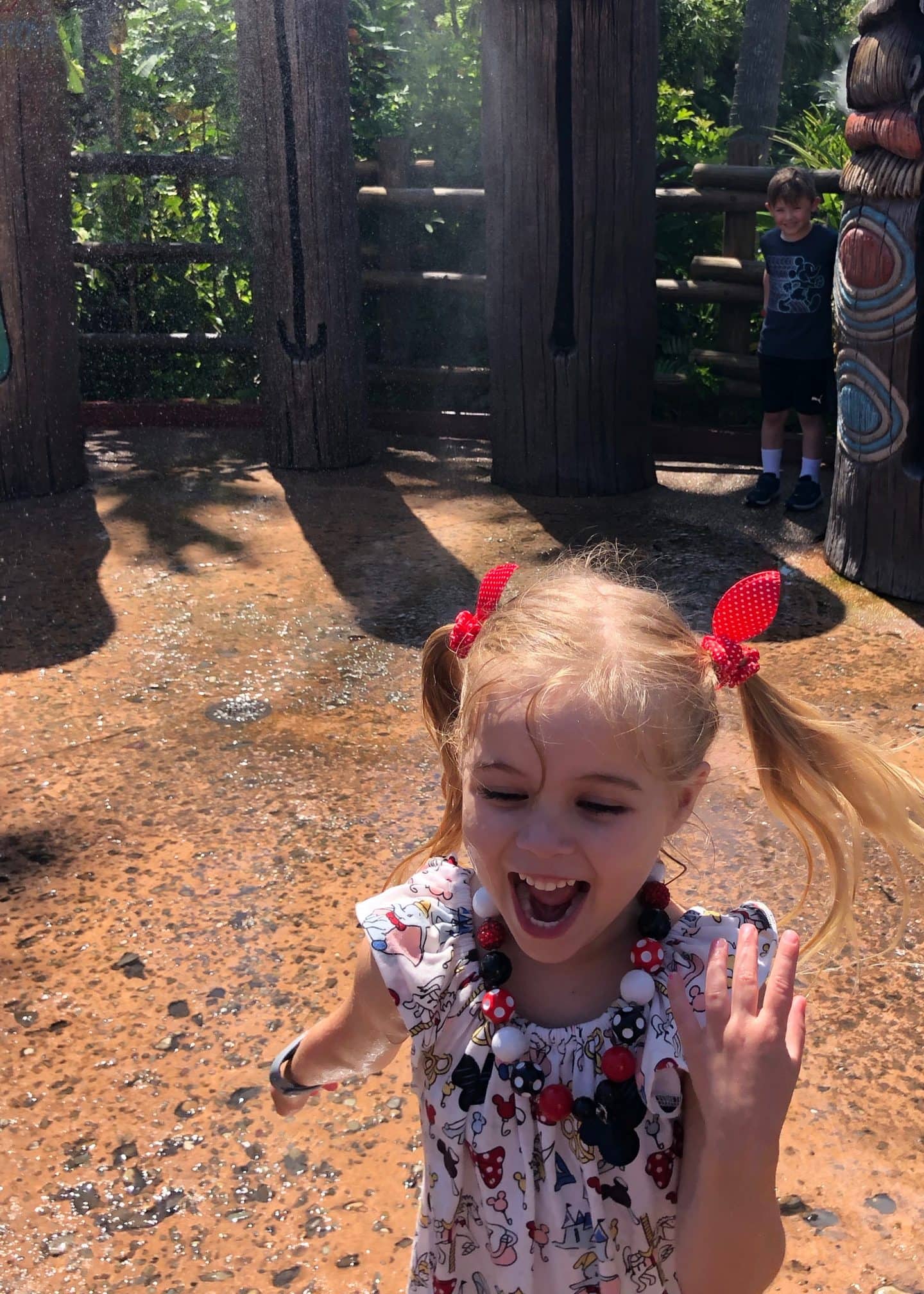 playing in water in Adventureland at magic kingdom