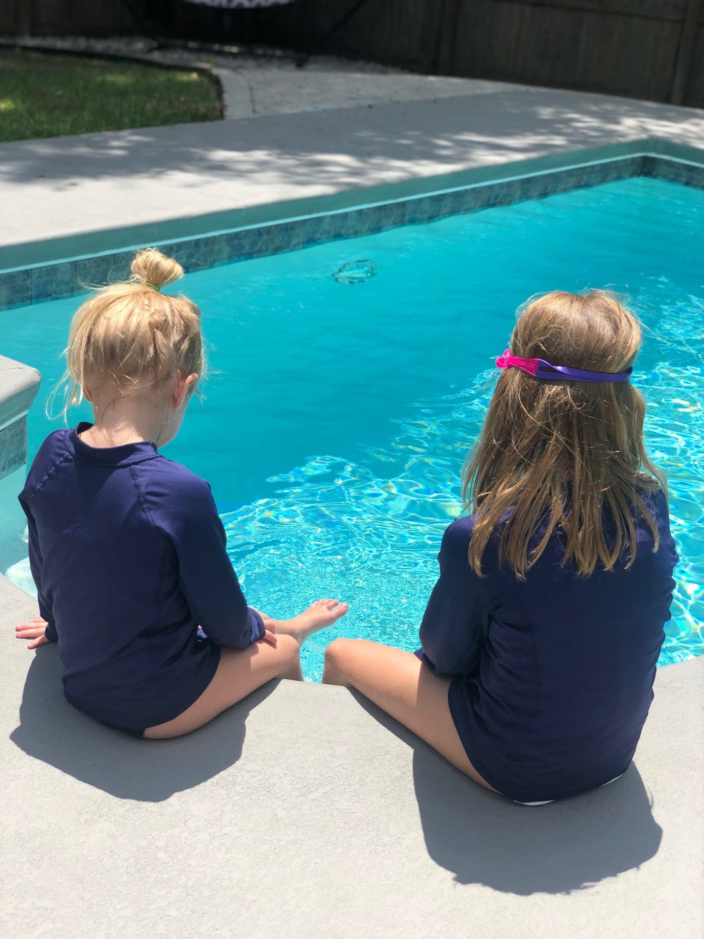 girls wearing rash guards in pool