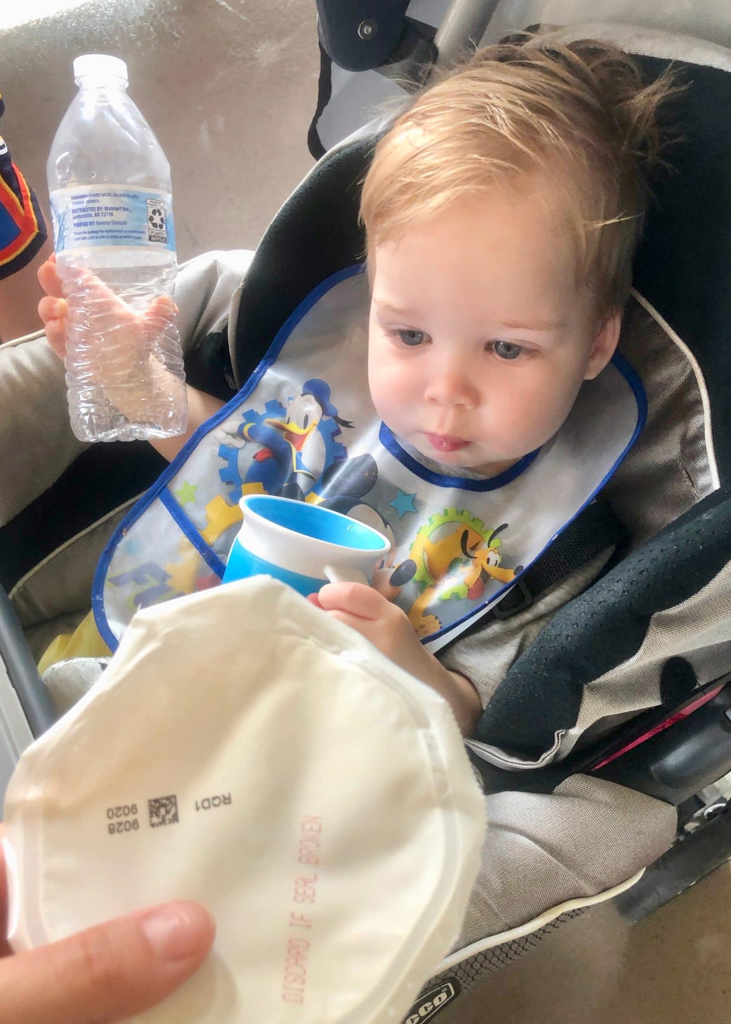 toddler eating breakfast in stroller at Disney World