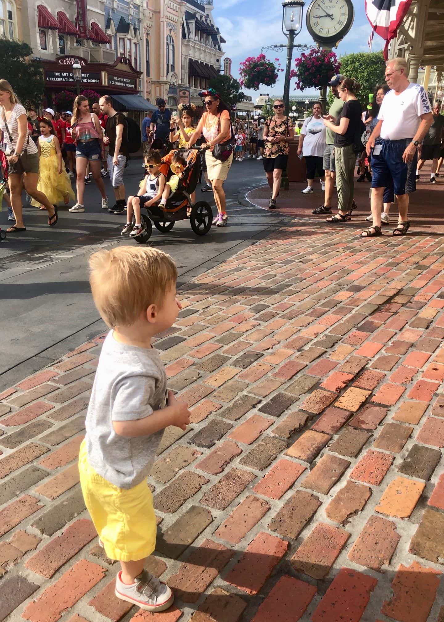 toddler boy walking down Main Street at magic kingdom Disney World