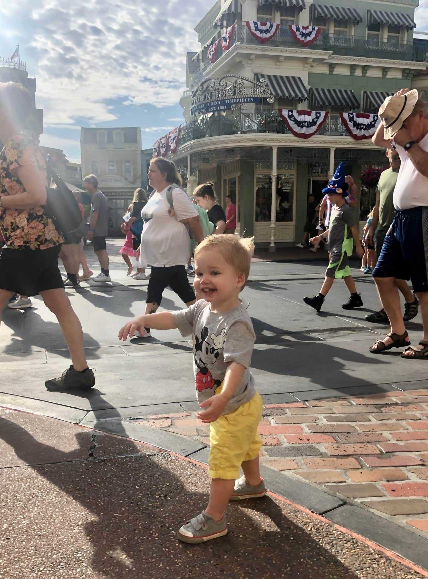 toddler boy walking down Main Street at magic kingdom Disney World
