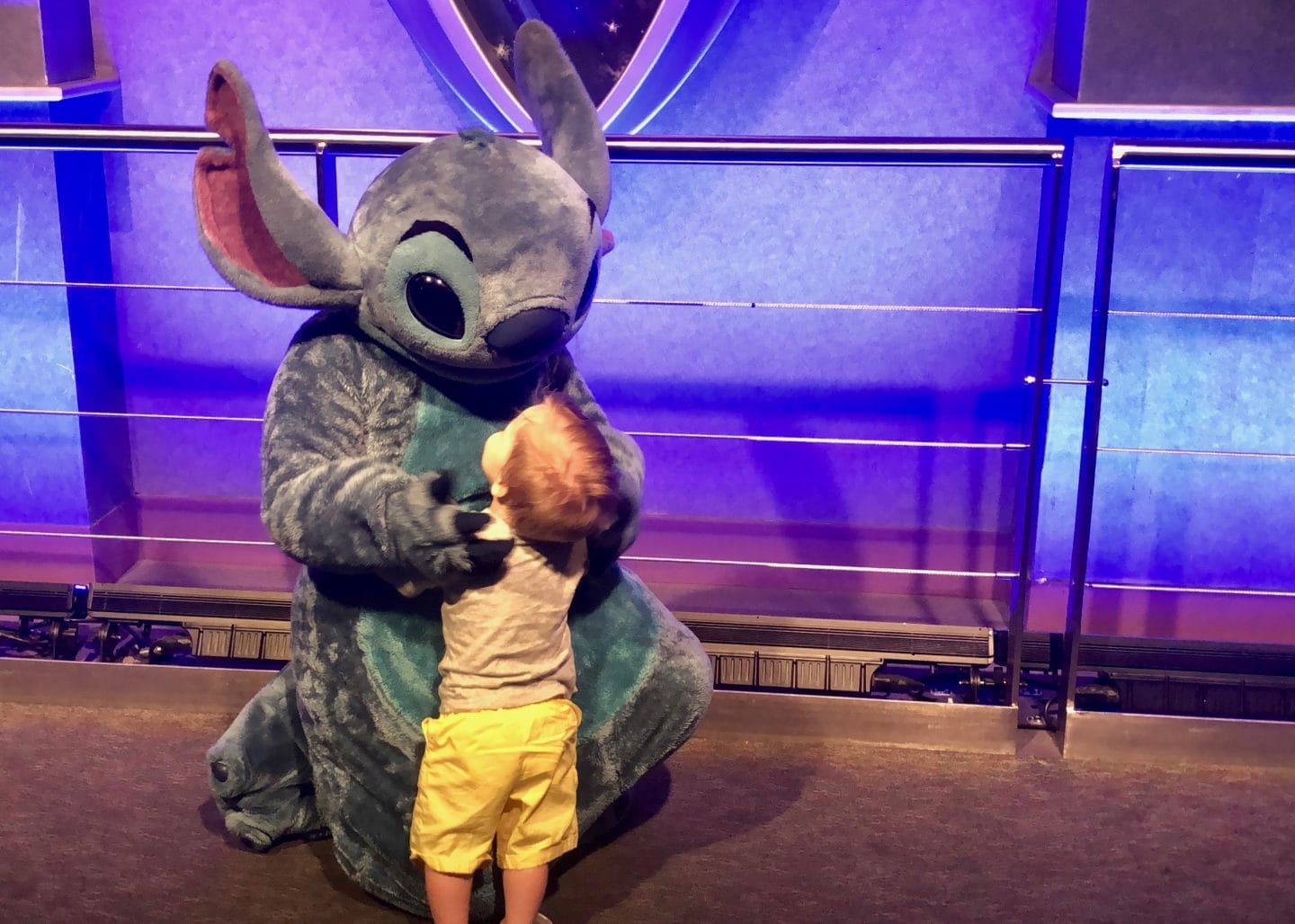 toddler boy meeting stitch at Disney World magic kingdom