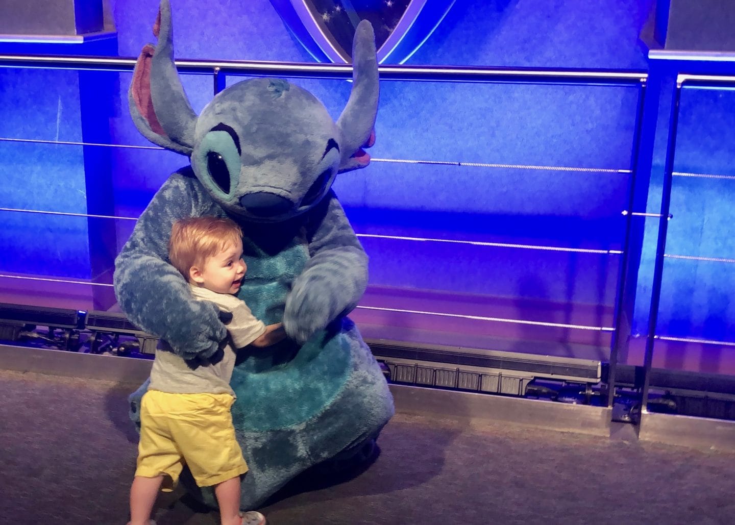 toddler boy meeting stitch at Disney World magic kingdom