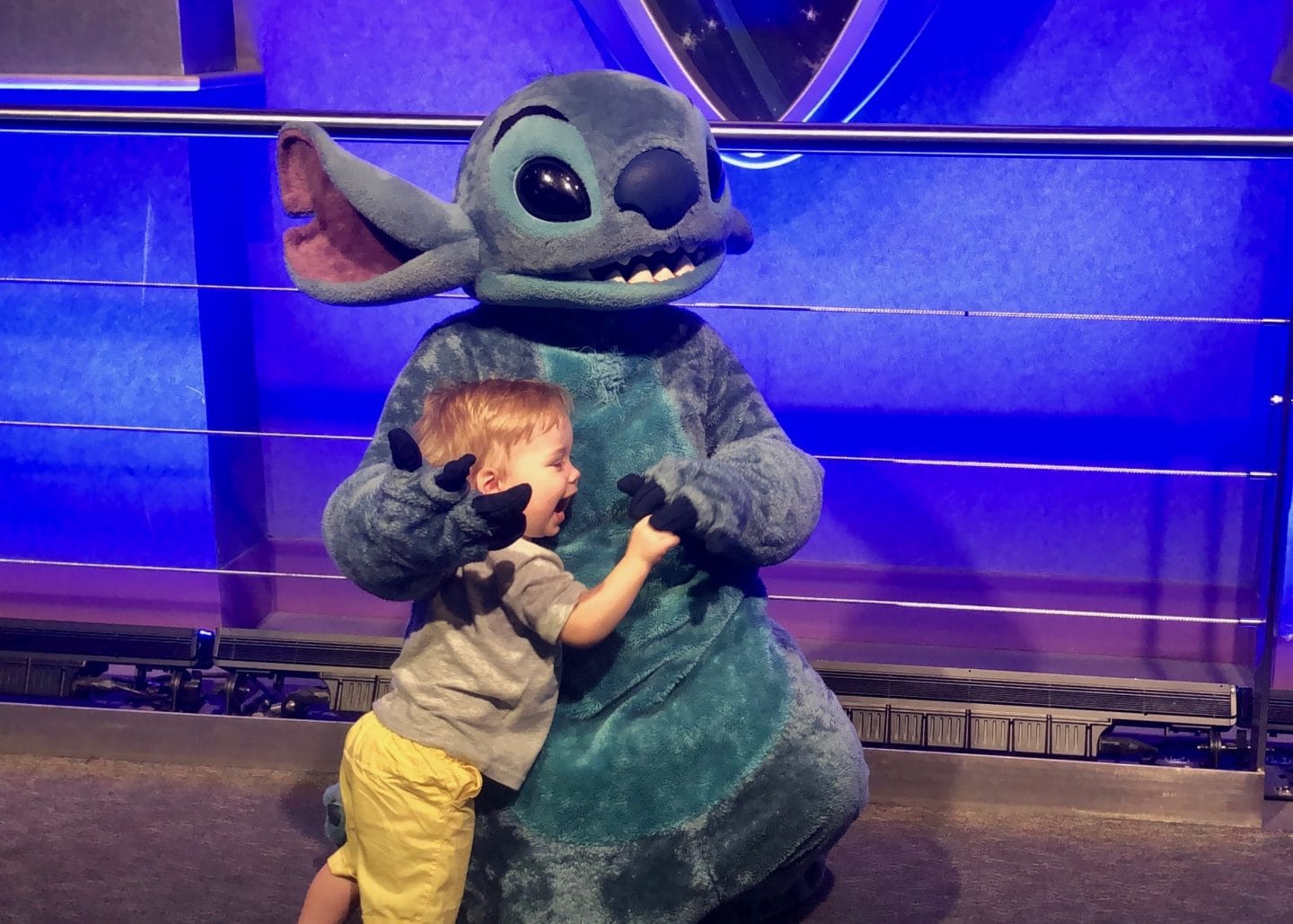 toddler boy meeting stitch at Disney World magic kingdom