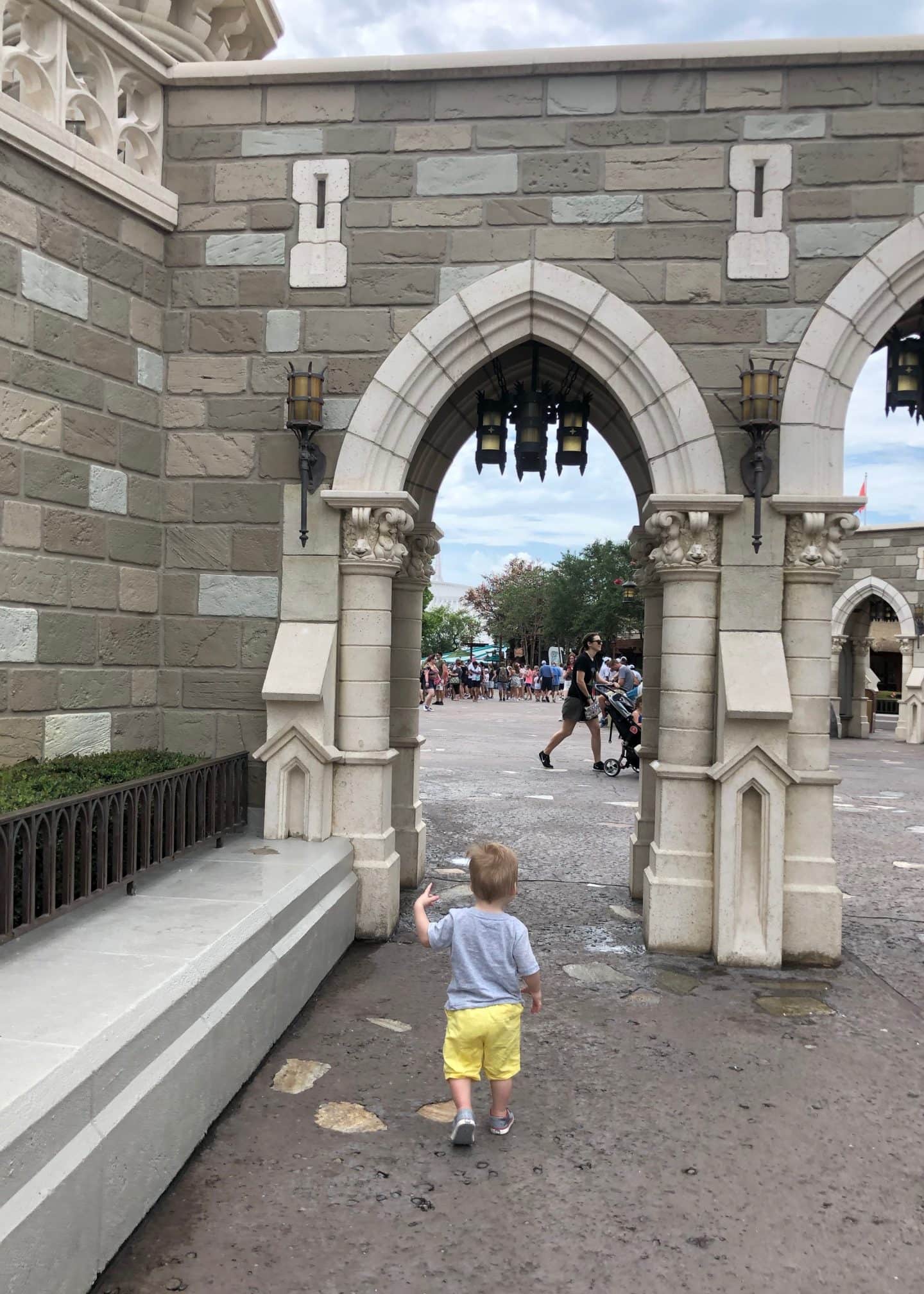 toddler boy exploring fantasyland at magic kingdom in Disney World 