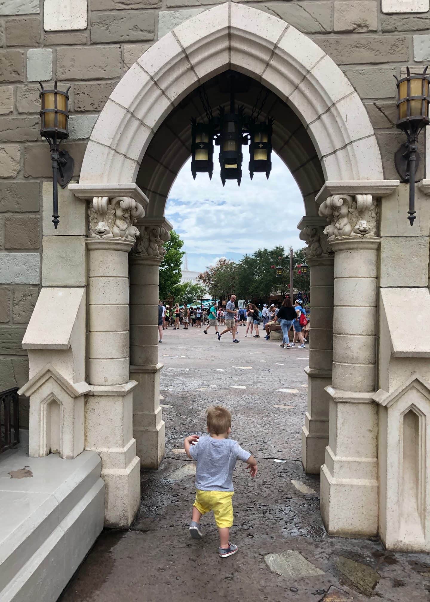 toddler boy exploring fantasyland at magic kingdom in Disney World 