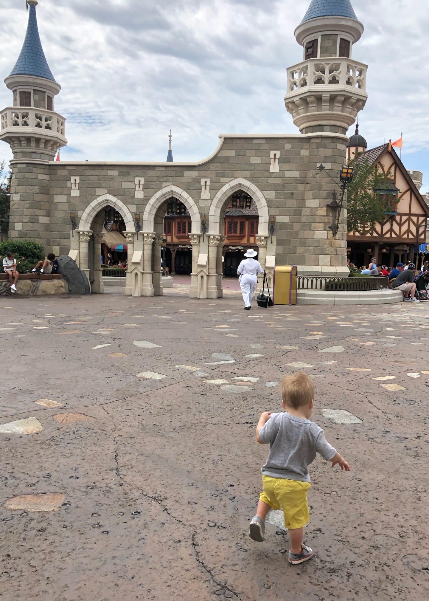 toddler boy exploring fantasyland at magic kingdom in Disney World 