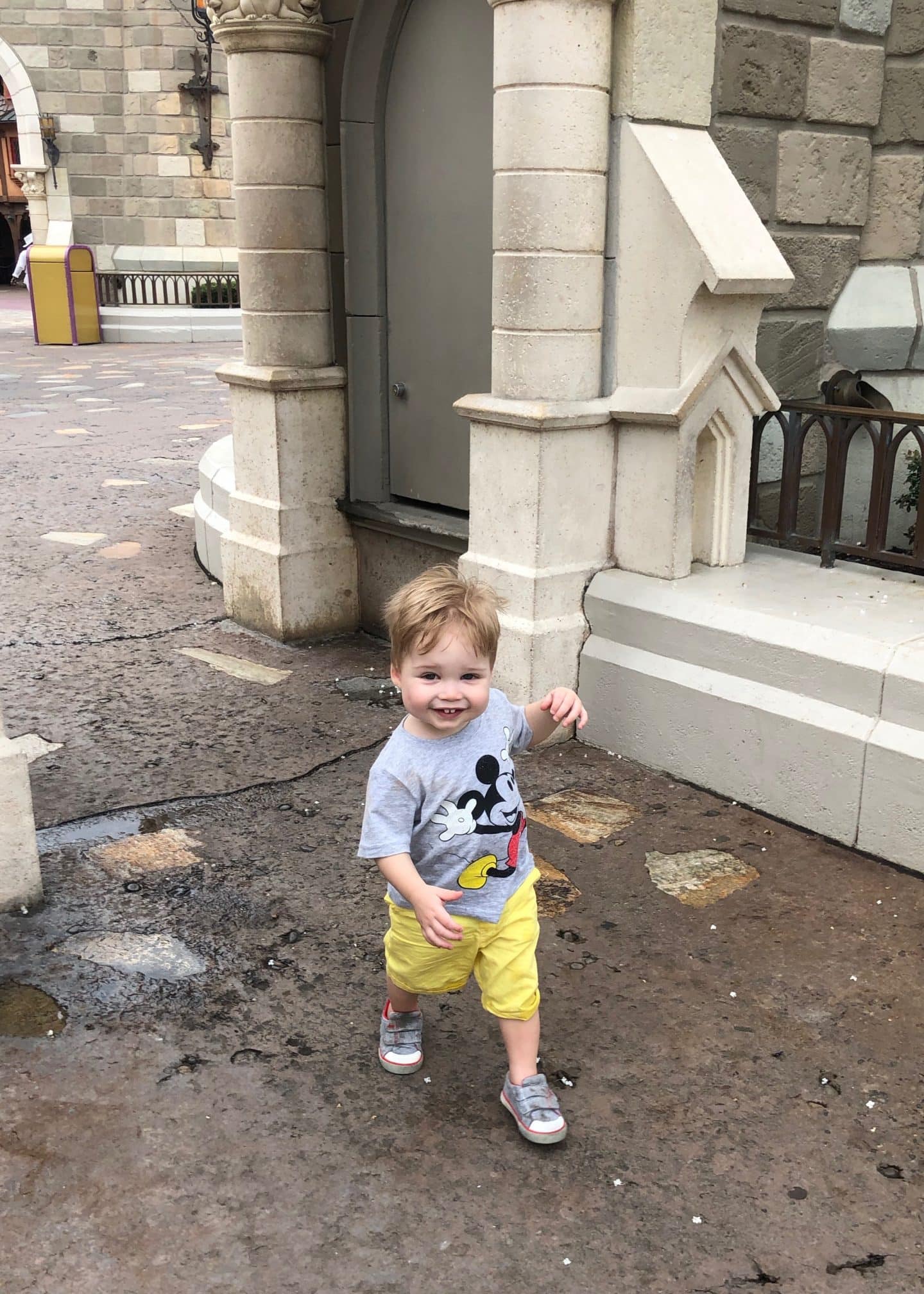 toddler boy exploring fantasyland at magic kingdom in Disney World 