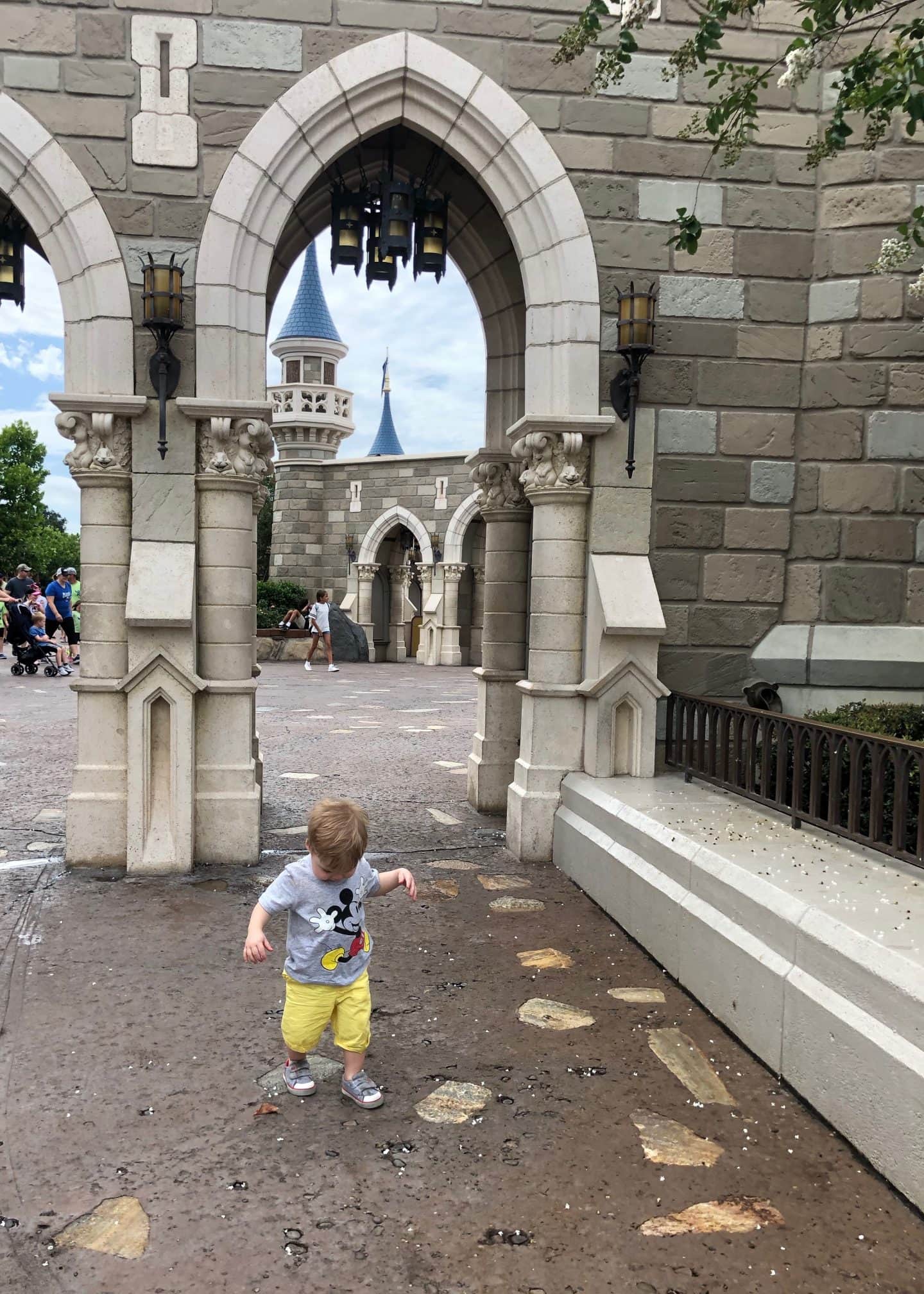 toddler boy exploring fantasyland at magic kingdom in Disney World 