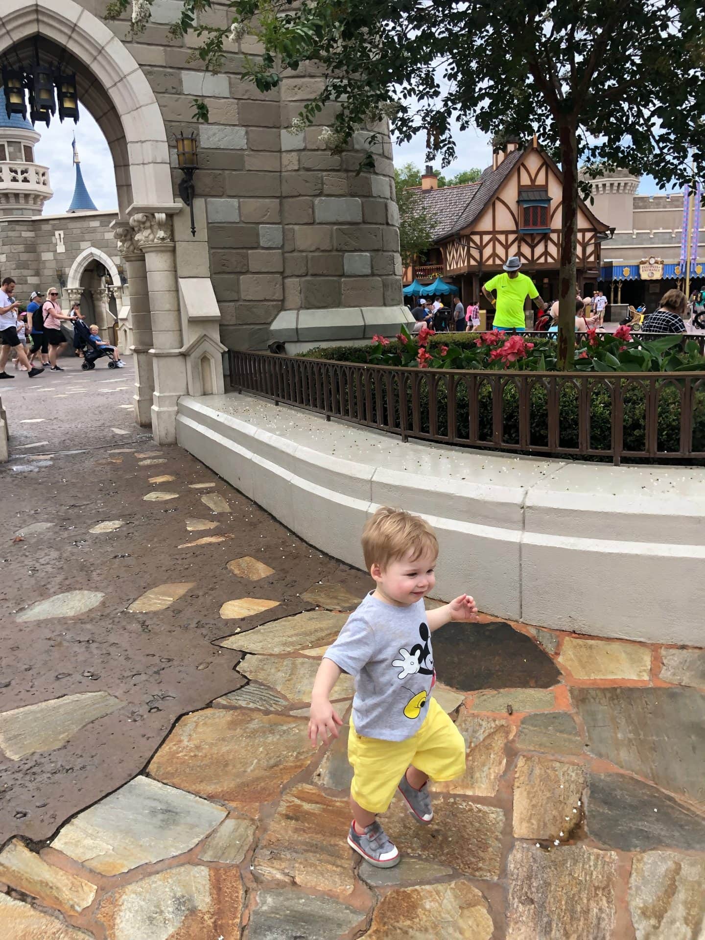 toddler boy exploring fantasyland at magic kingdom in Disney World 