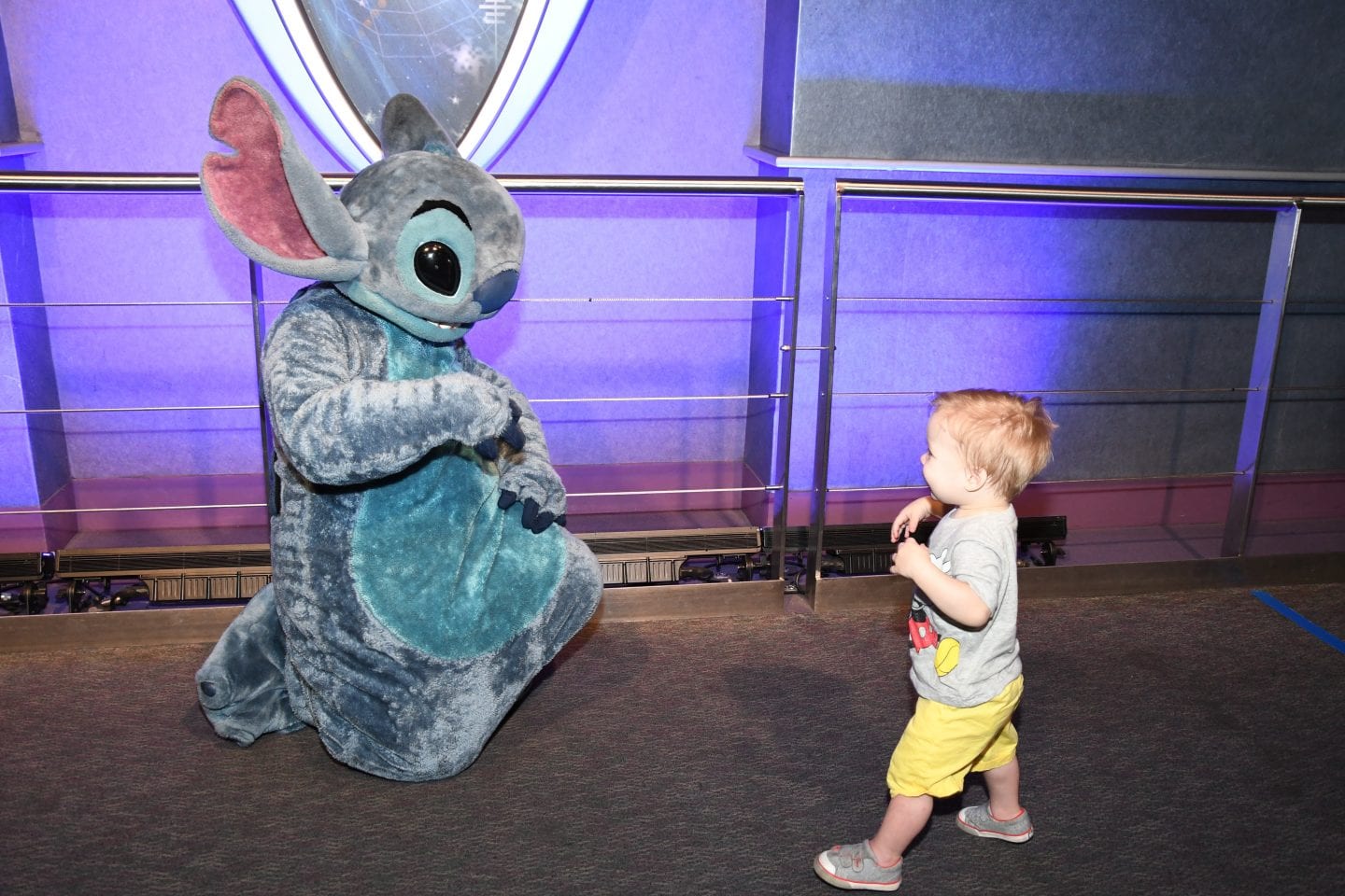 toddler boy meeting stitch at Disney World magic kingdom