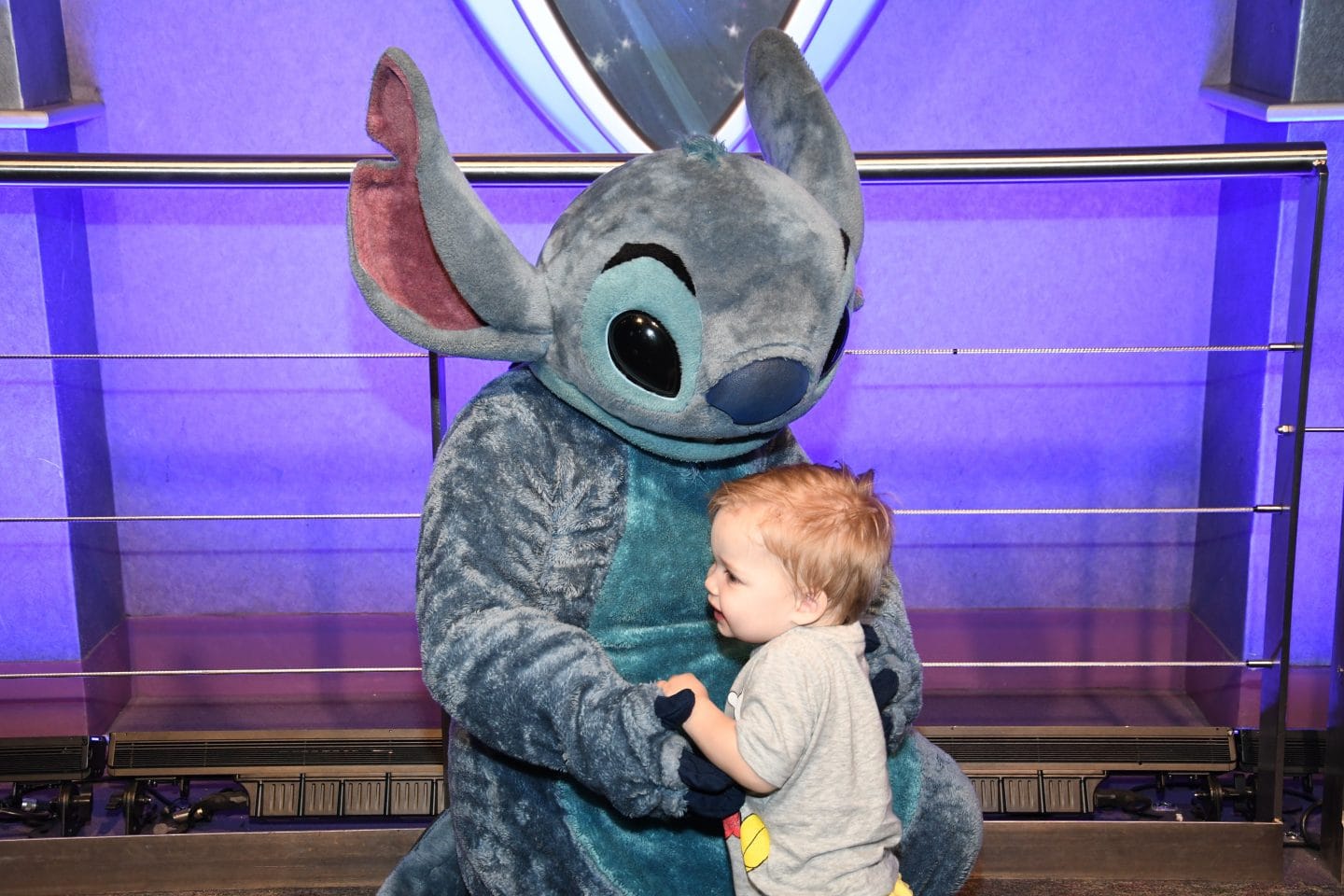 toddler boy meeting stitch at Disney World magic kingdom