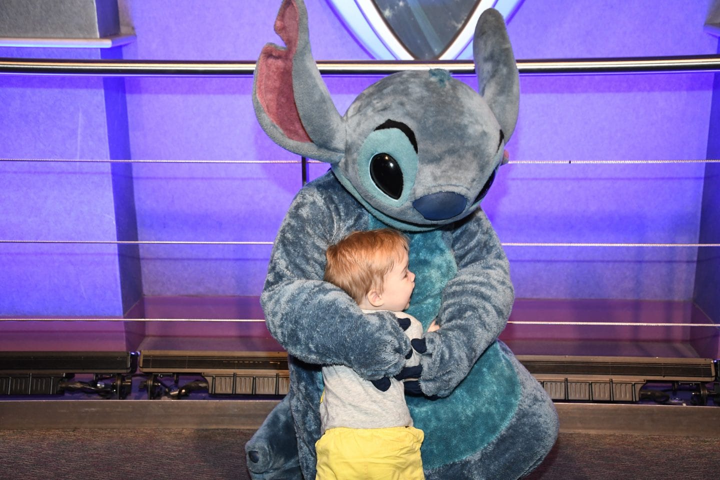 toddler boy meeting stitch at Disney World magic kingdom