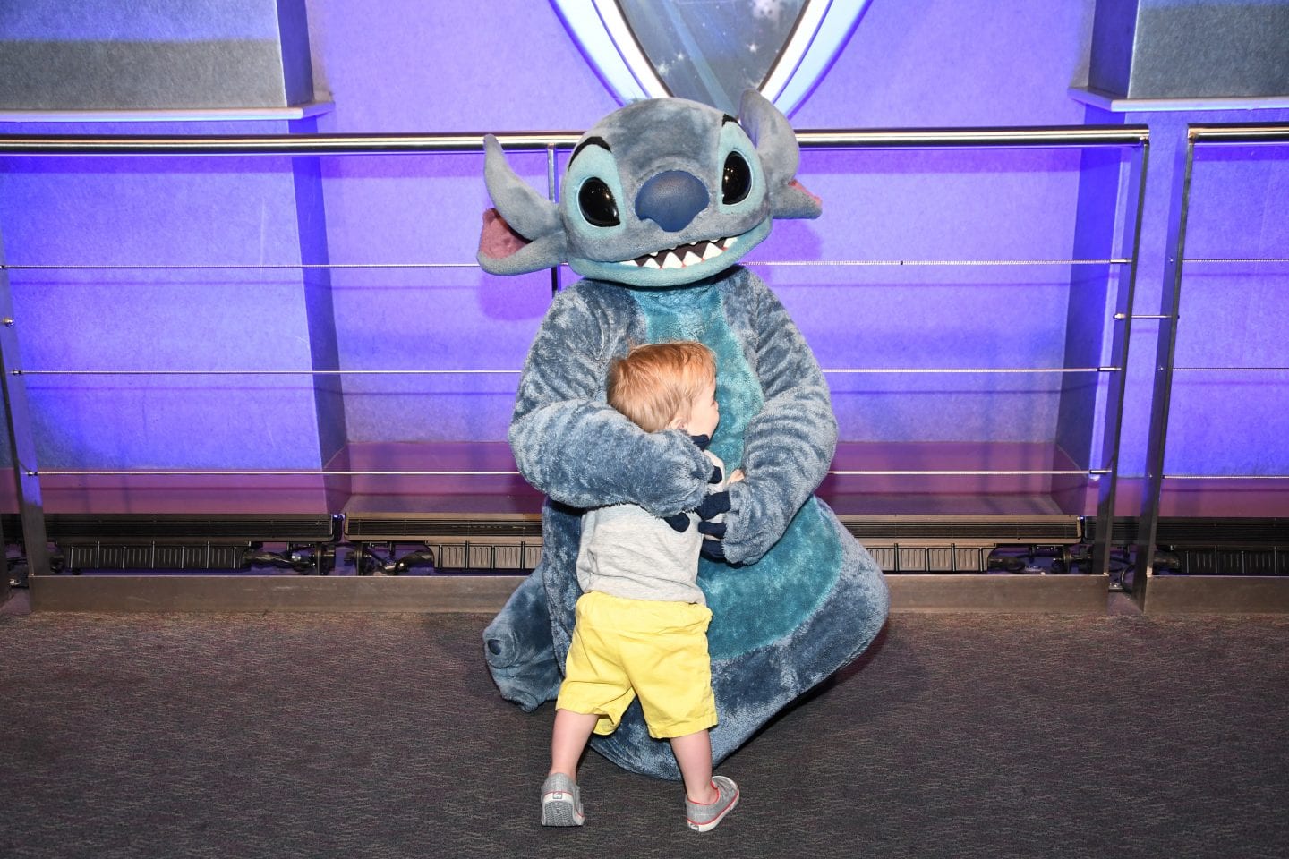 toddler boy meeting stitch at Disney World magic kingdom