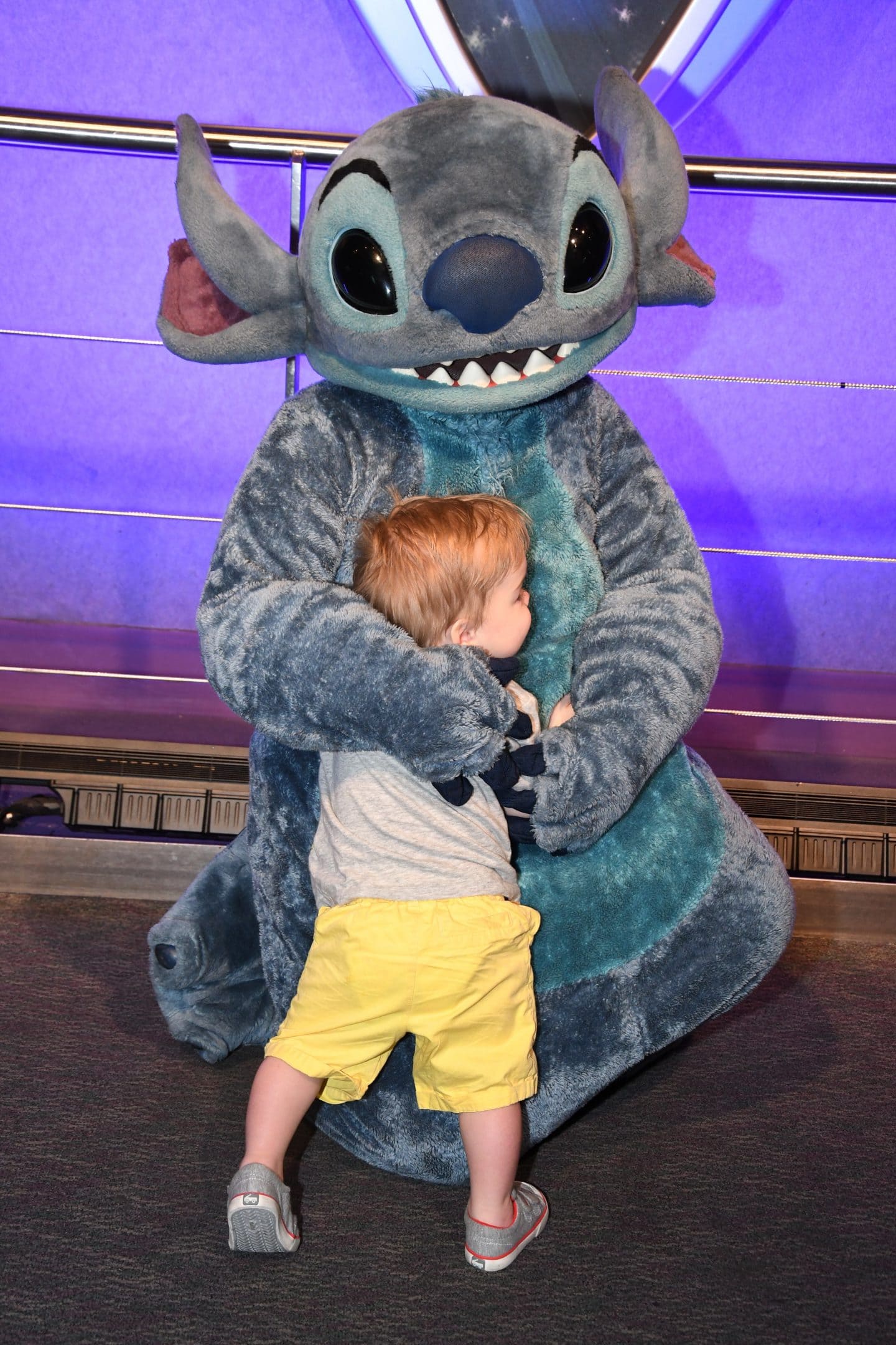 toddler boy meeting stitch at Disney World magic kingdom