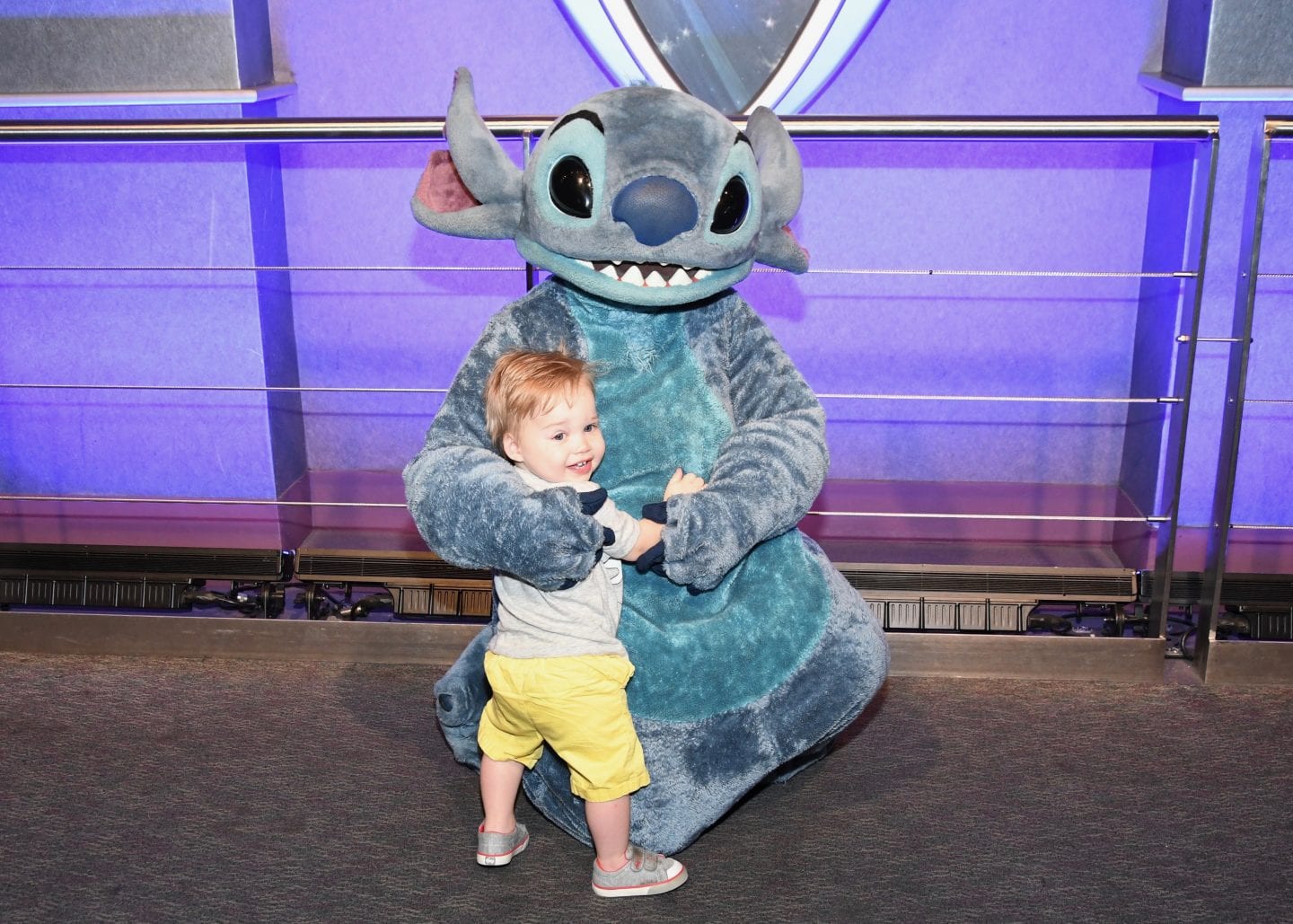 toddler boy meeting stitch at Disney World magic kingdom