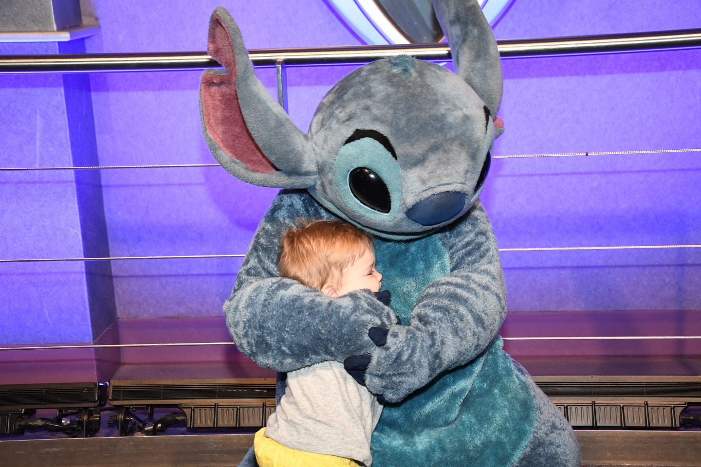 toddler boy meeting stitch at Disney World magic kingdom