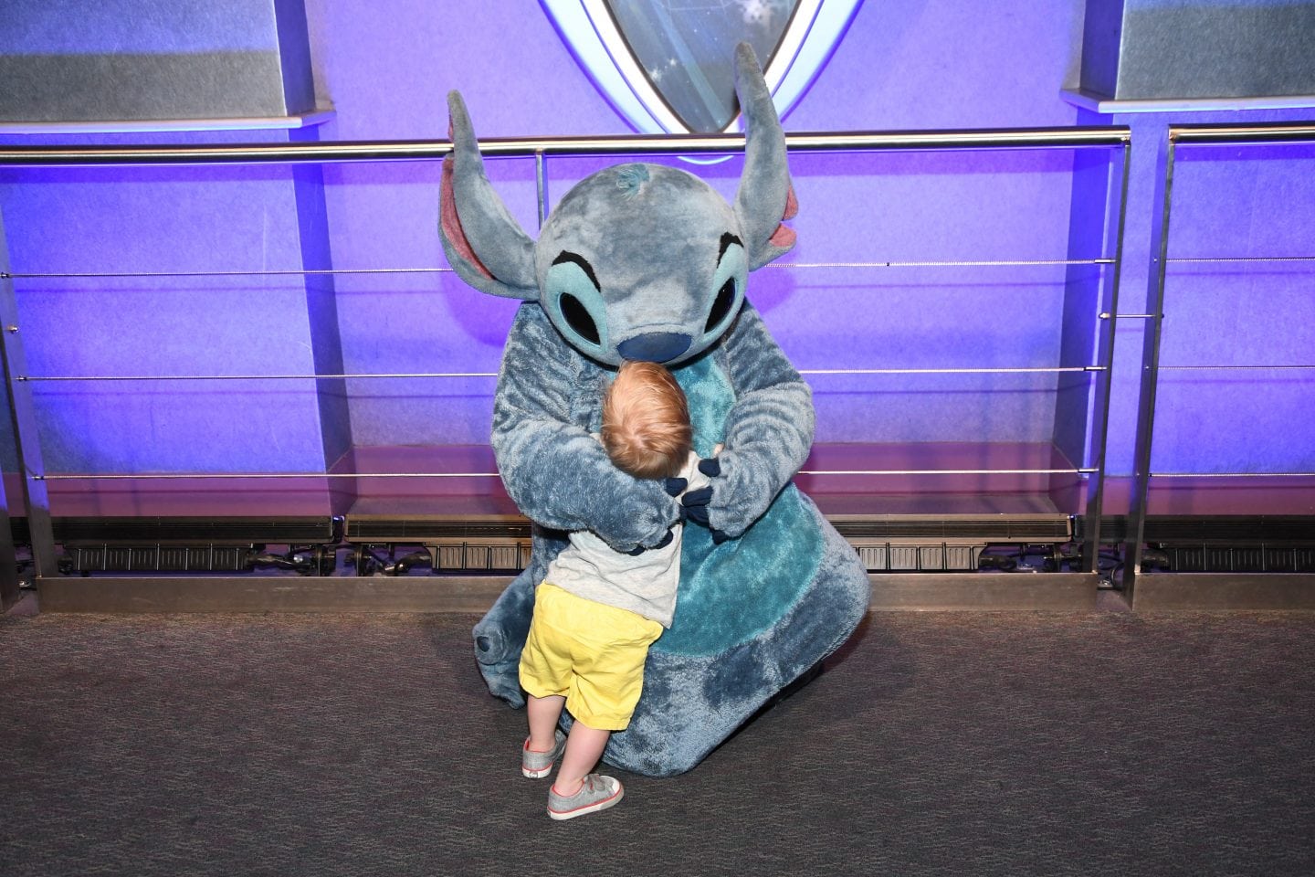 toddler boy meeting stitch at Disney World magic kingdom