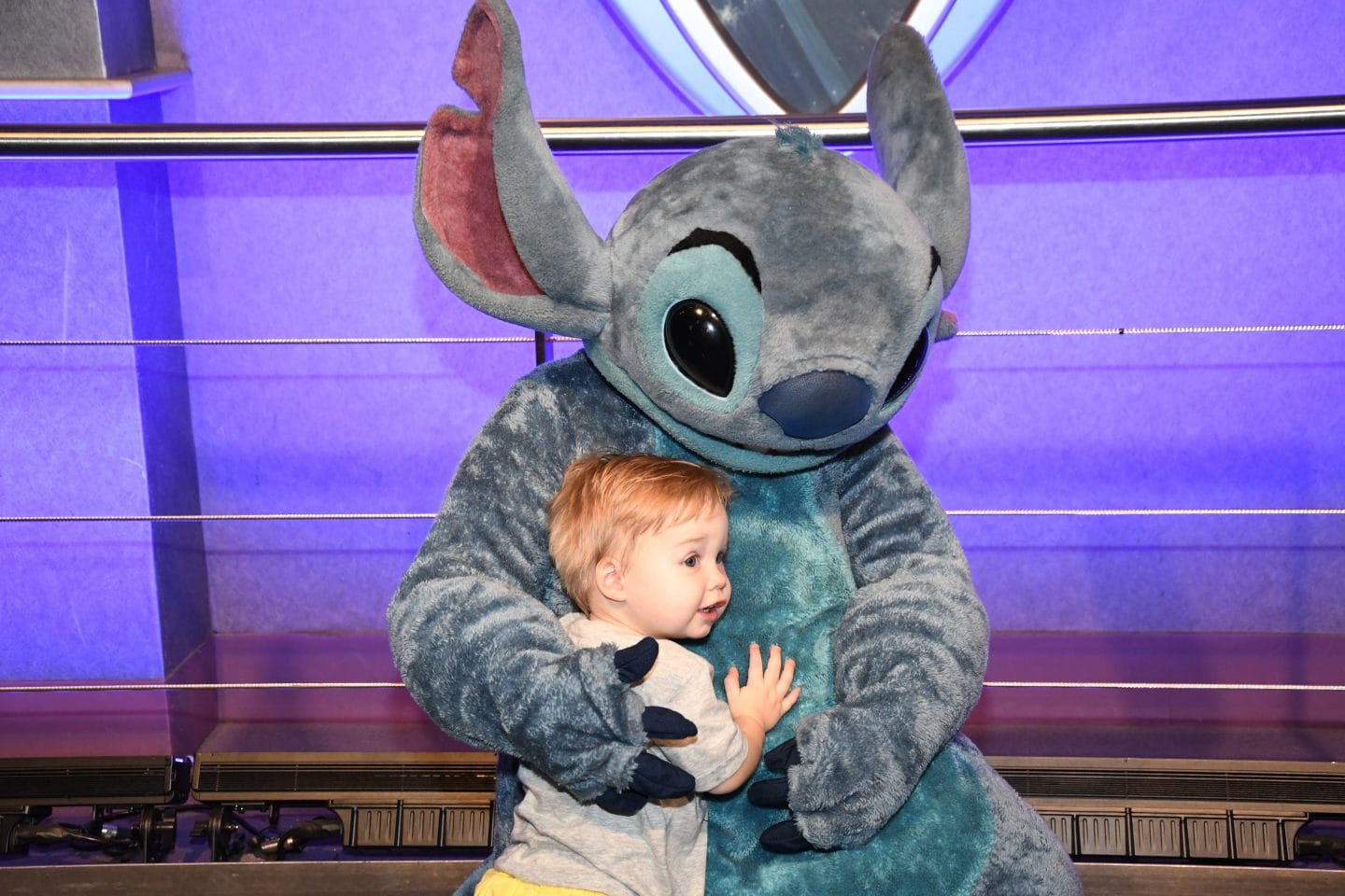 toddler boy meeting stitch at Disney World magic kingdom