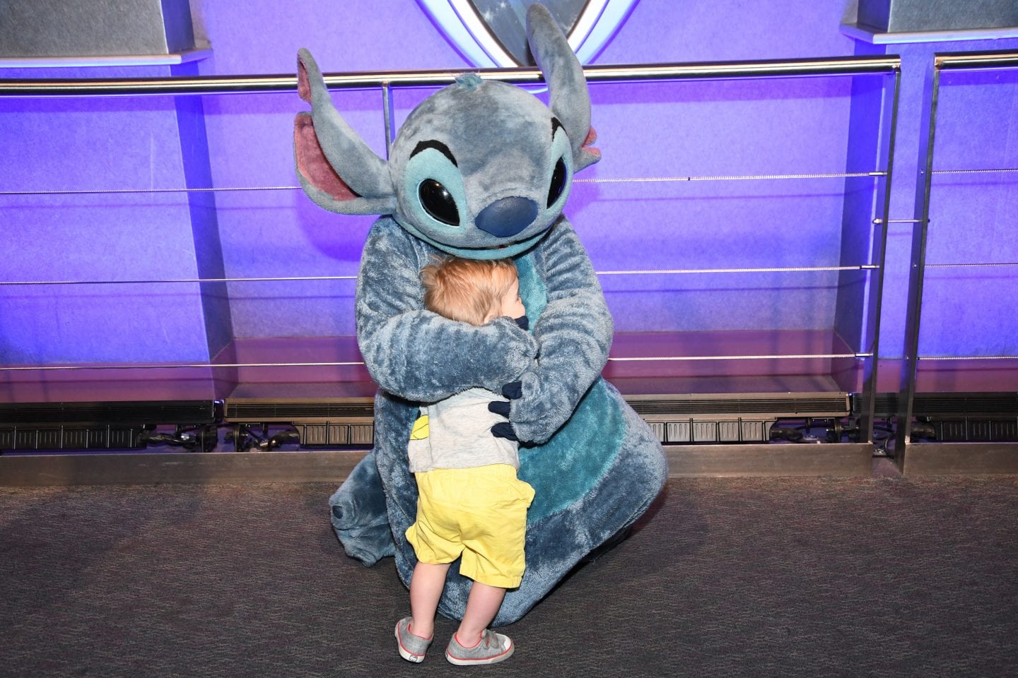 toddler boy meeting stitch at Disney World magic kingdom