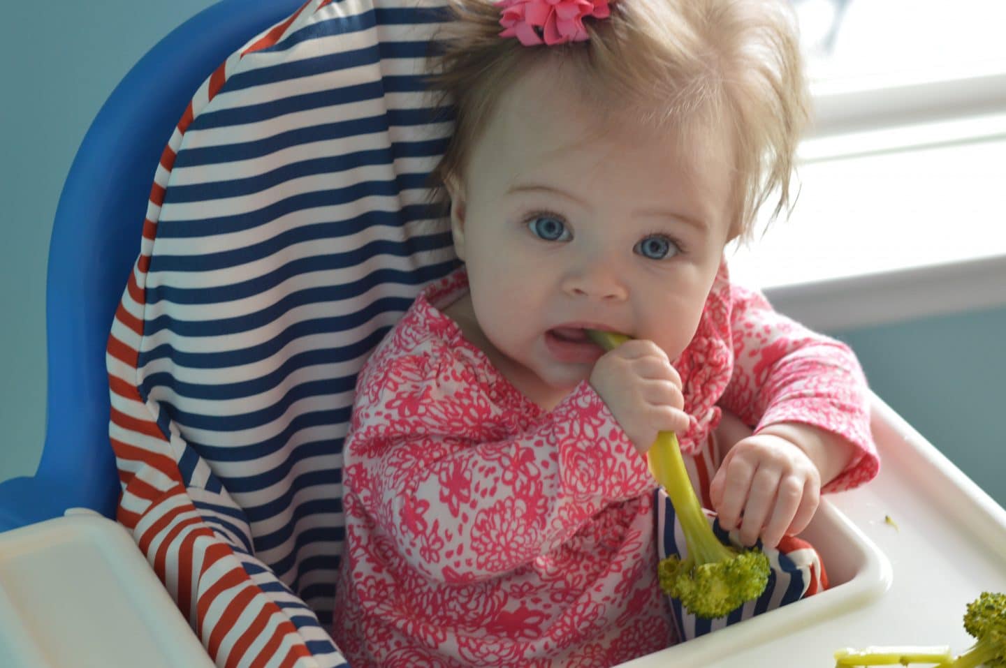 simple guide to baby led weaning - third baby enjoying food in high chair