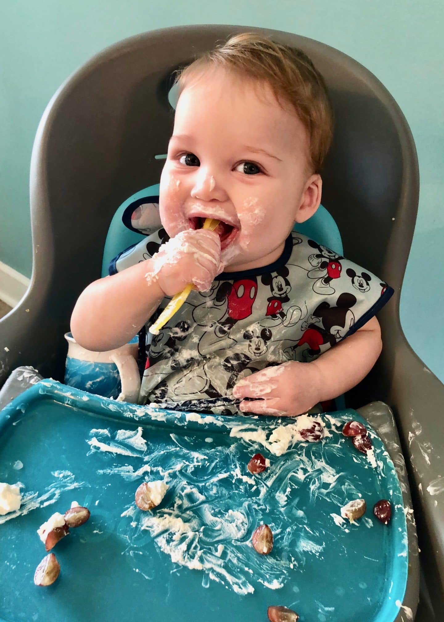 messy baby enjoying food using blw method