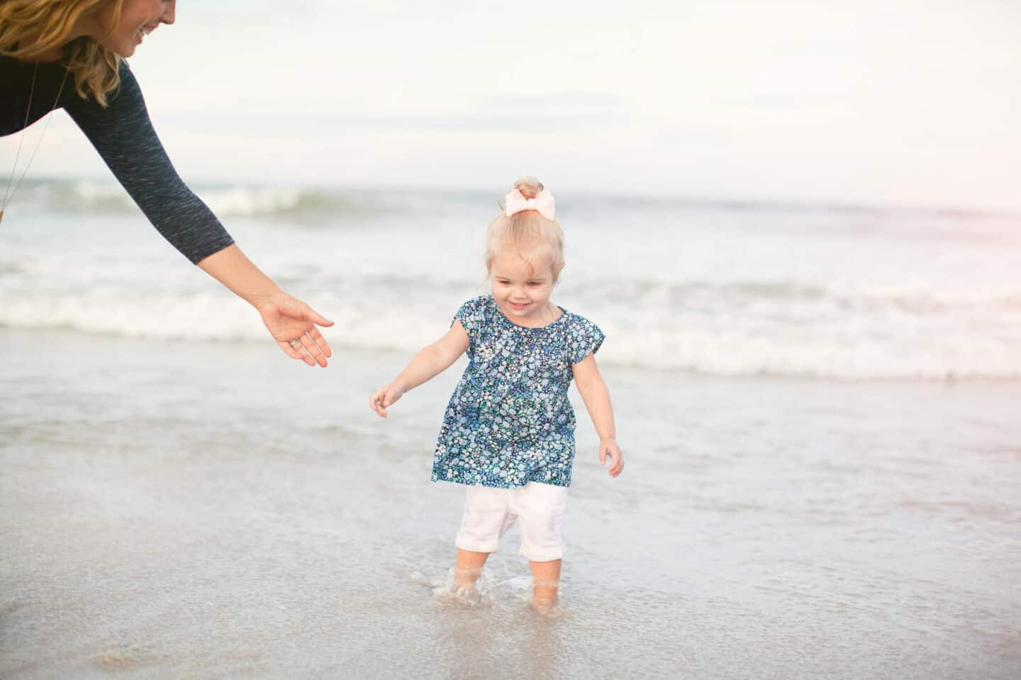 little girl walking in the ocean water