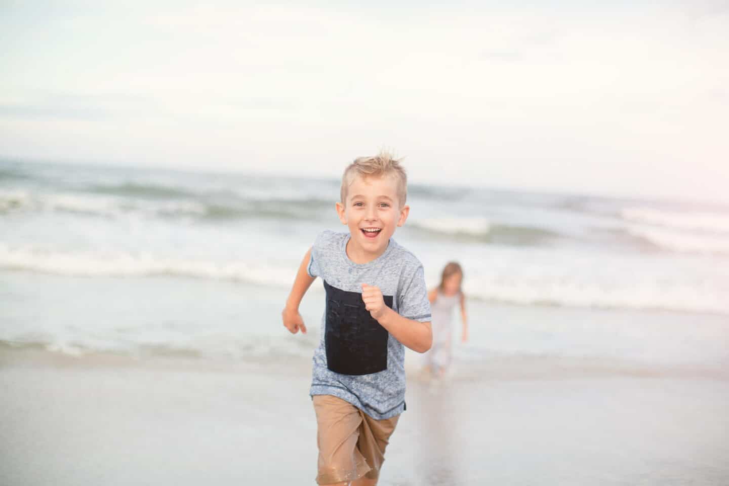 five year old boy running at the beach - candid beach photos