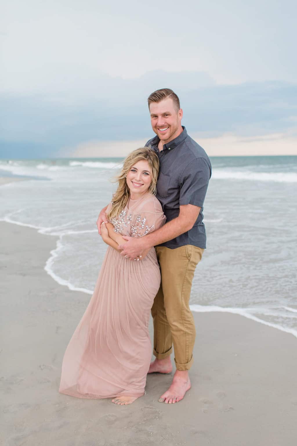 couple on the beach in fancy outfits 