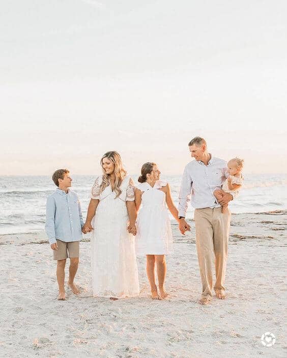 family walking on beach during beach family photos