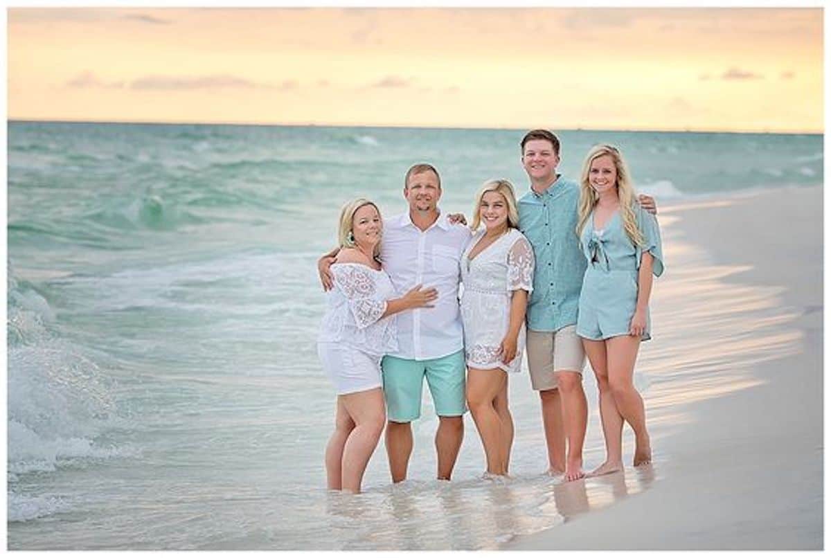 blue and white beach family photos at sunset